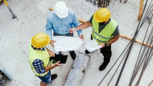 Engineers on construction site, high angle view of employees in construction industry