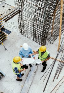 Engineers on construction site, high angle view of employees in construction industry